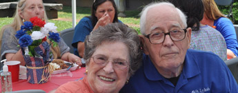 An elderly couple smiling